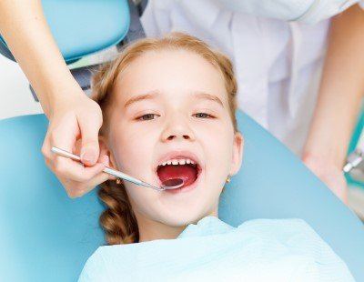 Smiling child in dental chair 